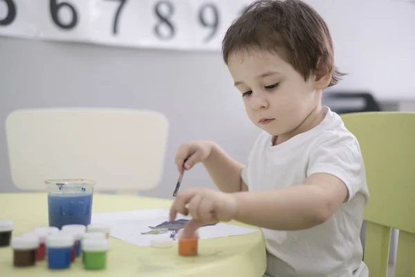 Kid boy playing with play clay at home or play-school — Stock Photo, Image