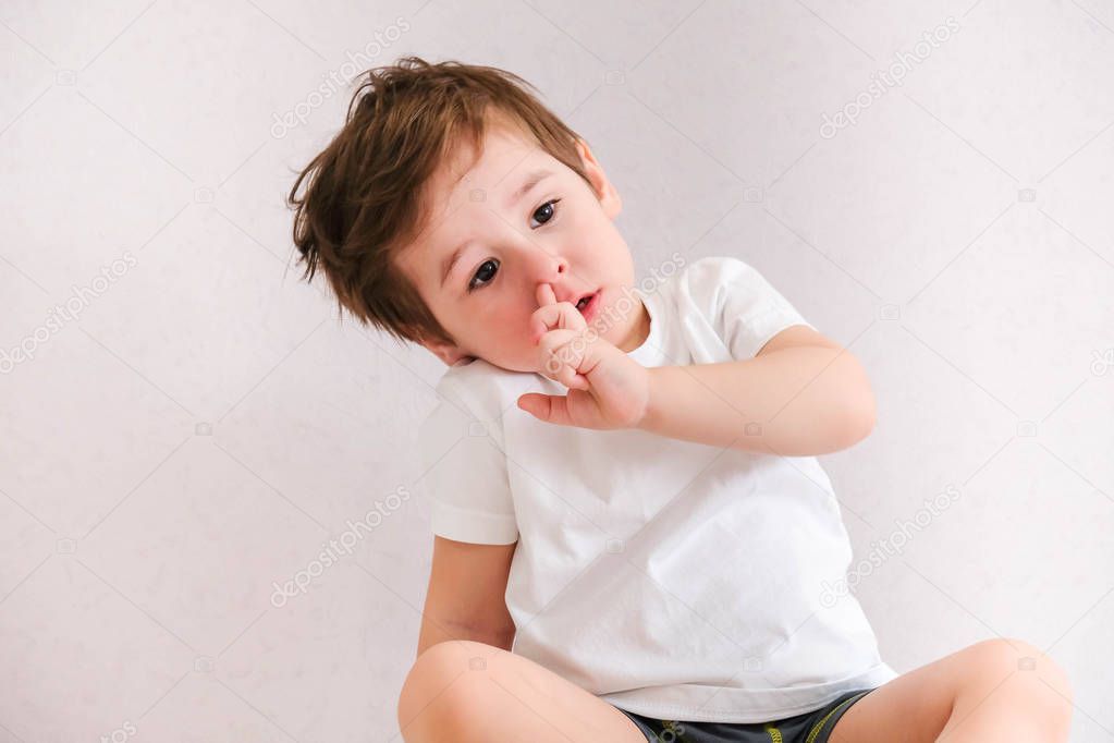 funny baby toddler blonde boy picking his nose