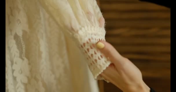 Close up of female hands checks the quality of the dress, syntheticl clothes. fashionable trendy look. slow motion shot — Stock Video