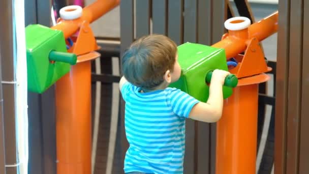 Boy is three years old, plays pirates with his friends, shoots a toy gun — Stock Video