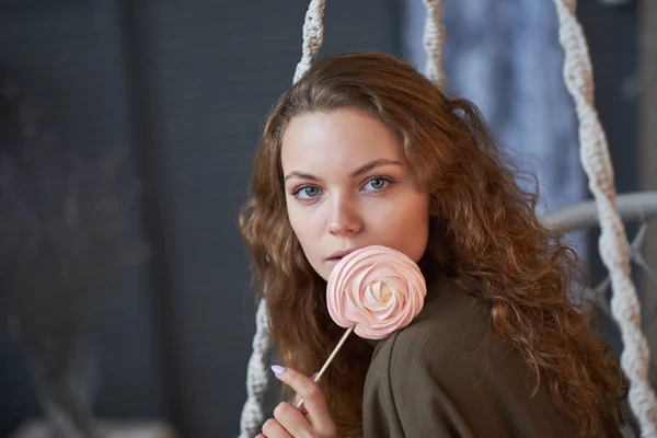 pretty young woman eating candies at home