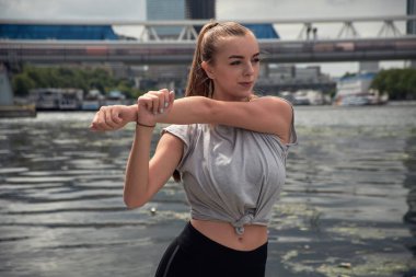 genç kadın büyük bir şehrin sokakta bir egzersiz yapar. güzel atletik kız