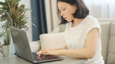 yavaş çekim. Modern ofiste çalışan ve bilgisayar dokunmatik ekran kullanarak gülümseyen iş kadını Closeup portre, monitör bakarak