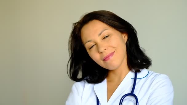 Slow motion close up of a beautiful young woman Lady Doctor Looking at Camera. Concept of profession, medicine and healthcare, medical education. — Stock Video