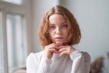 Güzel kıvırcık bir kızın portresi. Penceredeki gizemli yüz..