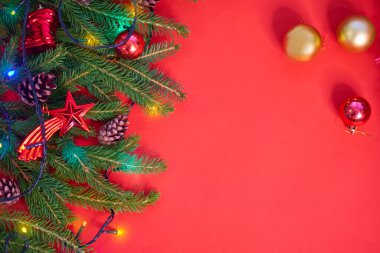 Noel arkaplanında kırmızı tuval arka planında Noel ağacı var. Mutlu noel kartları. Kış tatili teması. - Mutlu yıllar. Mesaj için yer var. Noel arkaplan manzarası. Düz yatıyordu.