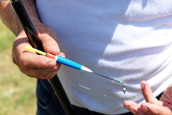 Fishing in river.A fisherman with a fishing rod on the river bank. Man fisherman catches a fish.Fishing, spinning reel, fish, Breg rivers. - The concept of a rural getaway. Article about fishing. — Stock Photo, Image