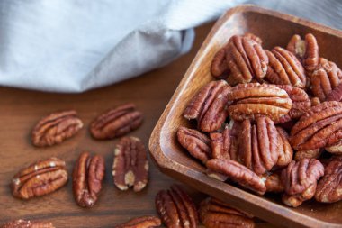 Tahta kasede fındıklar eski kahverengi masada, seçici odaklanma. Üst Manzara. Sağlıklı yemek ve atıştırmalık..