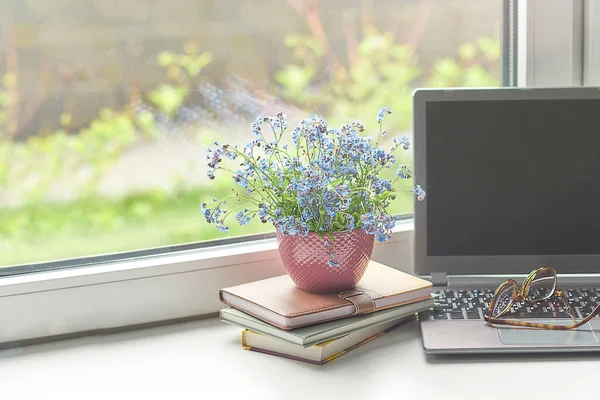 Workplace near the window with computer. Copy space. Modern laptop on desk near window at home. Morning time with warm light. working desk with a cup of coffee. business concept.