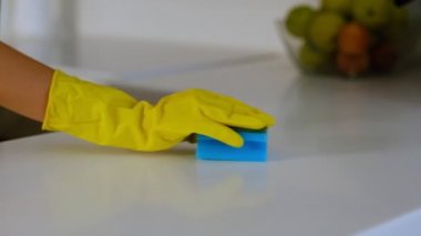 Kauçuk eldivenli, süngerli ve deterjanlı bir el. Kauçuk eldivenli, süngerli ve deterjanlı bir el.