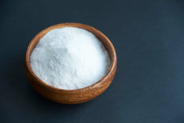 Glass bowl of baking soda. Spoonful of bicarbonate.