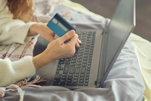 stock image Close-up womans hands holding a credit card and using computer keyboard for online shopping