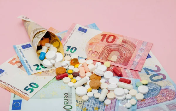Таблетки Обернуты Евро Банкнотами Евро Розовом Фоне Медицинская Концепция — стоковое фото