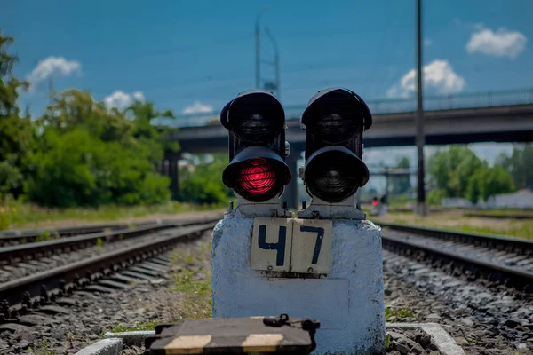 Traffic light shows red signal on railway. Red light. Railway tracks with red light semaphore.