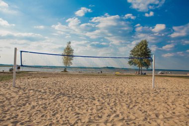 Güneşli bir günde plaj voleybolu ağı. Kumsal ve denizle dolu..