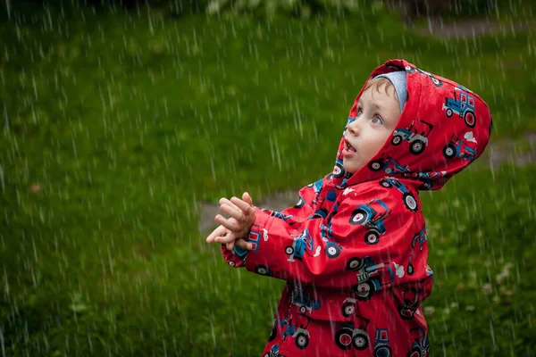 Little Boy Waterproof Jacket Tractors Catch Rain Child Having Fun — Stock Photo, Image