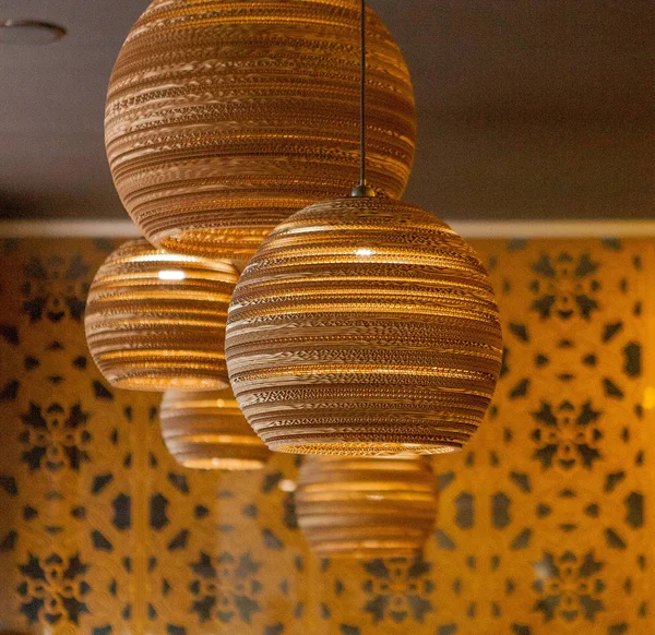 interior of restaurant with big lamps in golden light.