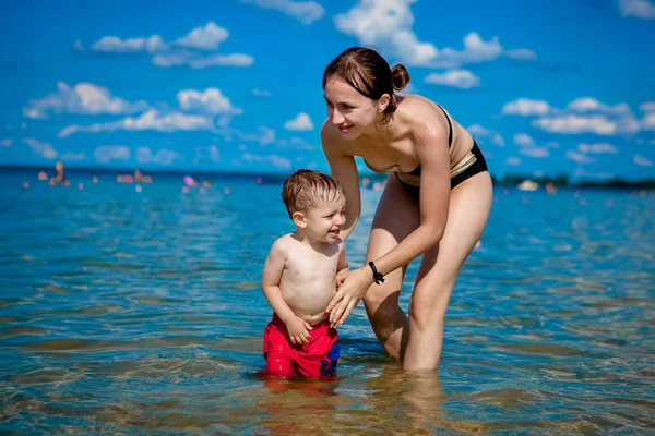 年轻母亲和一个小男孩夏天在湖上玩水 家庭幸福 乡村家庭休息 夏天温暖的日子 — 图库照片