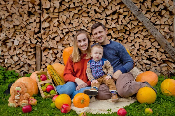 Thanksgiving, Halloween holiday. Happy family sit next to pumpkins