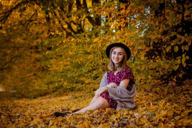 Sonbaharda parkta duran zarif bir kadın, sonbahar konsepti.