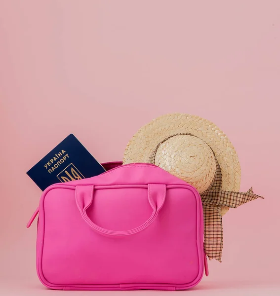 Traveler pink suitcase and passport document,purse on pink background, Journey and travel concept.