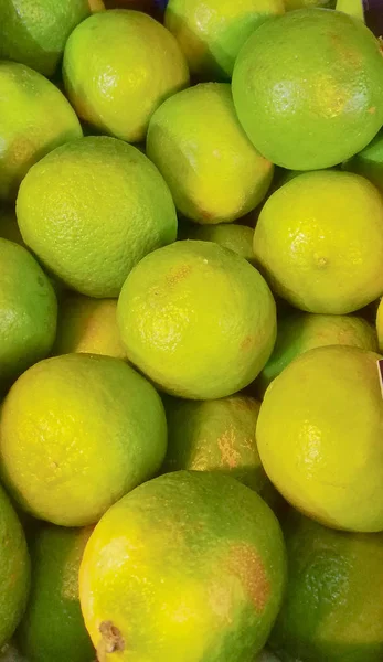 Fresh ripe limes as background, lime citrus fruit close up.