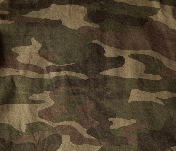 Closeup of military uniform surface. Texture of fabric, close-up, military coloring.