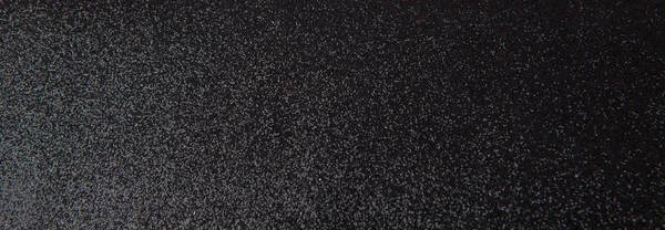 Silver sequins pattern. Sparkling sequins on black wool fabric as background.
