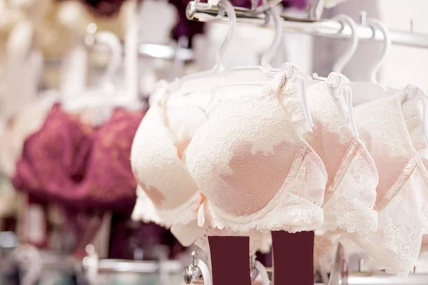Woman Chooses Pink Lace Bra Hanging on Rack in Lingerie Store. Concept of  Shopping, Customer during Sale, Female Fashion, Differen Stock Photo -  Image of body, concept: 146133556
