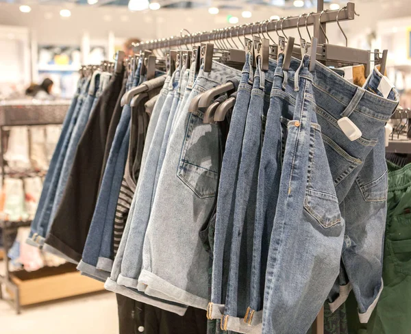 Jeansshorts på butikshyllan. Moderiktiga kläder på shel — Stockfoto