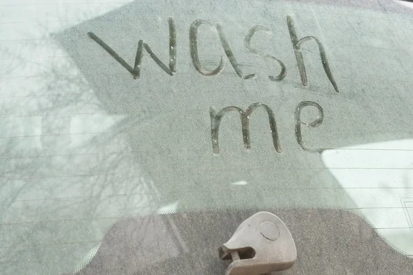 Write the words "wash me" on the very dirty surface of the car. Concept car wash Royalty Free Stock Photos