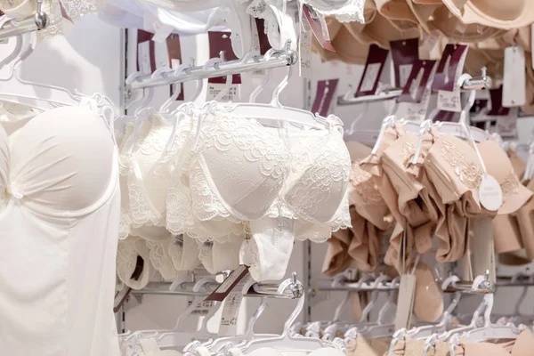 Premium Photo  A row of classic white bras on a hanger in a lingerie store  modern and fashionable interior of lingerie store