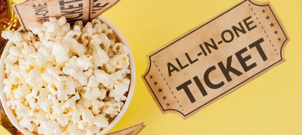 Movie tickets, film strips and popcorn on blue background. Copy space for text