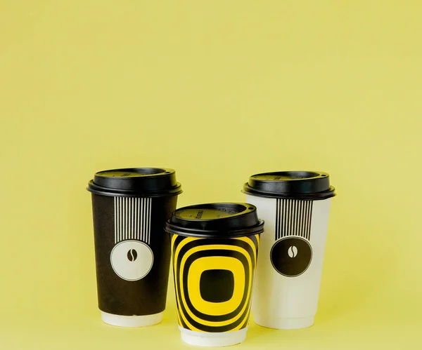 Take-out coffee in thermo cup on a yellow background. — Stock Photo, Image