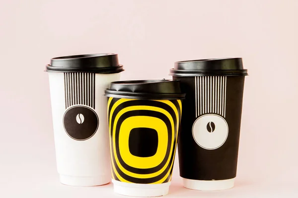 Take-out coffee in thermo cup on a pink background