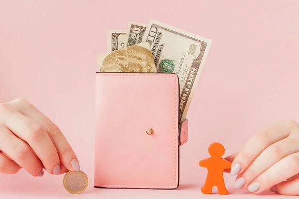 Bitcoin in de hand van een vrouw en dollars in roze portemonnee met krediet — Stockfoto