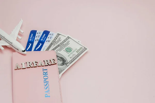 Inscrição "airfare", Airplane, air ticket and money on a pink — Fotografia de Stock
