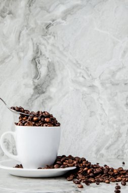 Mermer arka planda fincan ve kahve çekirdekleri siyah kahve. En iyi v