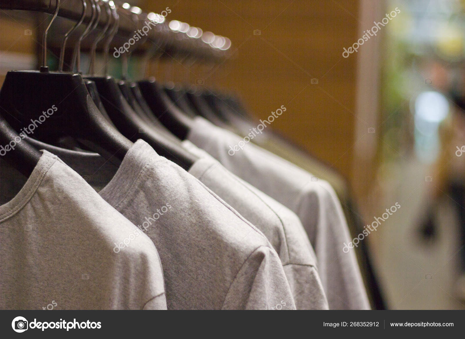 Grey t-shirts on hangers at clothing store close up view — Stock