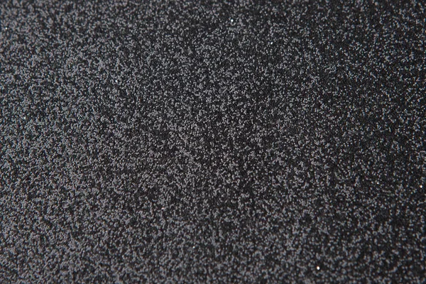 Silberpaillettenmuster. funkelnde Pailletten auf schwarzem Wollstoff — Stockfoto