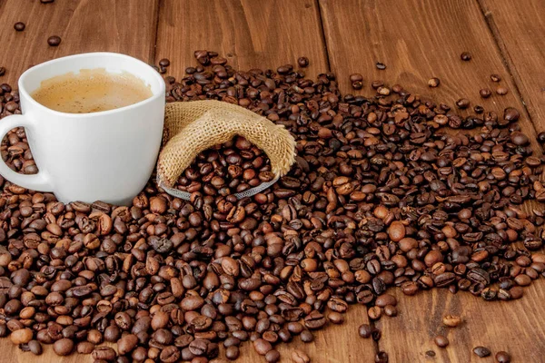 Coffee cup with coffee bag on wooden table. View from top