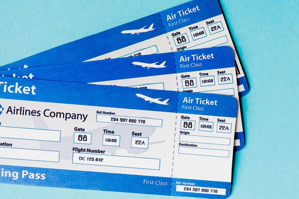 Air ticket on a blue background. Travel concept, copy space