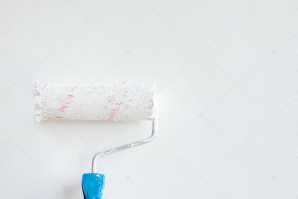 Woman hand holding a paint roller isolated on a white background
