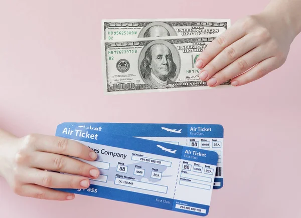 Passaporte, dólares e bilhete de avião na mão de mulher em um fundo rosa. Conceito de viagem, espaço de cópia — Fotografia de Stock