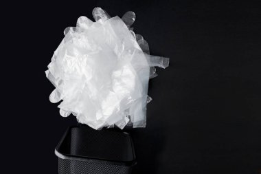 Kolları ile plastik torba, siyah bir arka planda bin eldiven. Geri dönüşüm için kullanılmış plastik torba. Konsept-ekoloji, plastik sellophane polietilen ile gezegen kirliliği