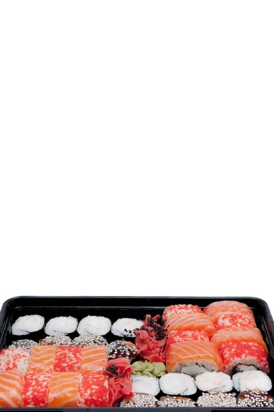 Big sushi set ib black plastic box on white background, top view close up, copy space — Stock Photo, Image