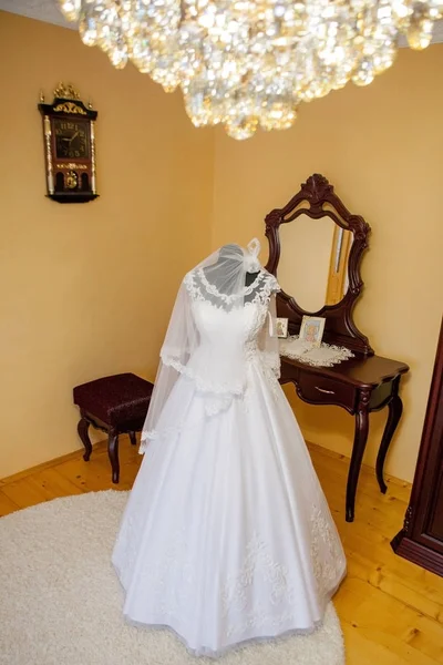 White wedding dress on a mannequin in the room