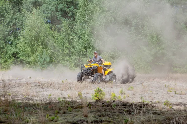 Homme conduisant un quad jaune VTT tout terrain véhicule sur une forêt de sable. Mouvement sportif extrême, aventure, attraction touristique . — Photo