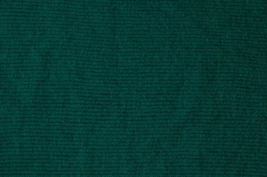 Koyu yeşil renkli bir tekstil malzemesinden. Doğal dokulu kumaş. Kumaş zemin