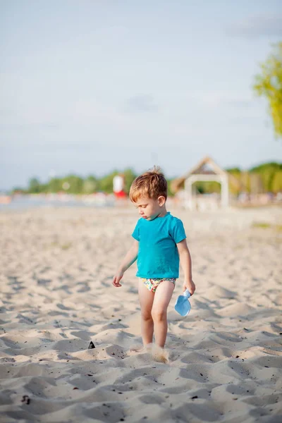 Chico jugando en la playa. Juego de niños en el mar en vacaciones familiares de verano — Foto de Stock